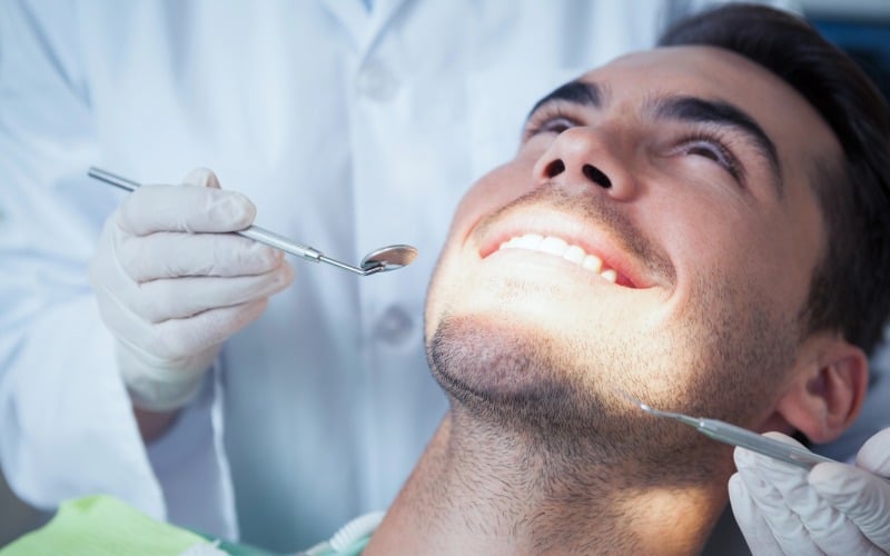close up of man having his teeth examined