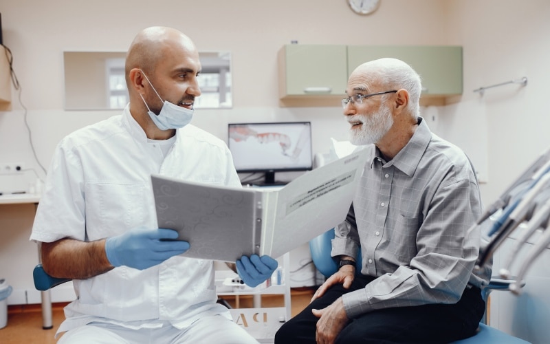 old man having consultation with the dentist