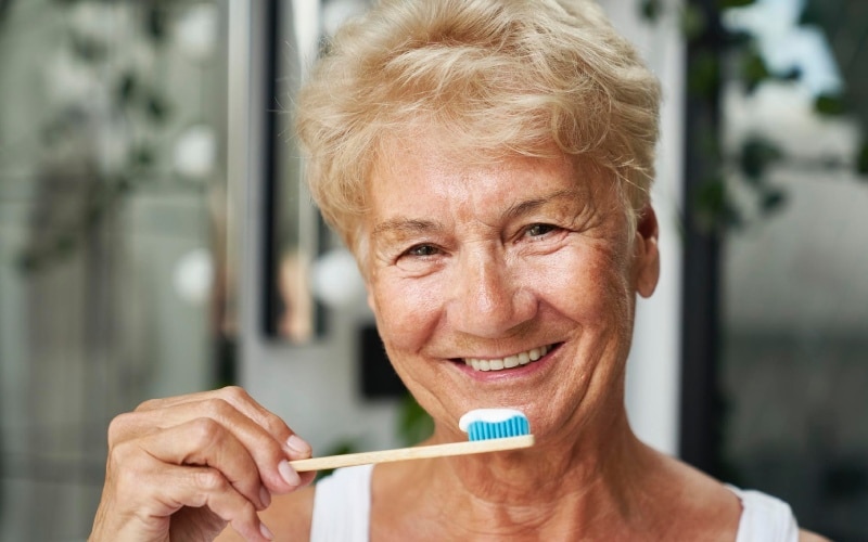 old man preparing his toothbrush